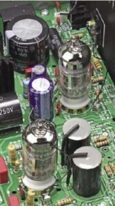The two 12AX7 (6922) double- triode amplifier / line driver valves - big polyprop, and elec-trolytic capacitors close by.