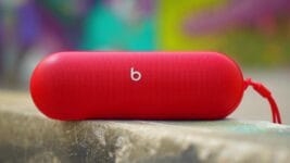 Beats Pill speaker in vibrant red outdoors