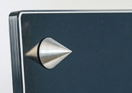 The massive, height-adjustable spikes are part of the stand.